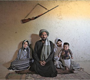 Portrait of Mohammed Fazal, 45, with his two wives (L-R) Majabin, 13, and Zalayha, 29 in the village on the outskirts of Mazar Al Sharif. Fazal was offered Majabin as a debt settlement when a fellow farmer could not pay after a night of playing cards. They have been married for six months.